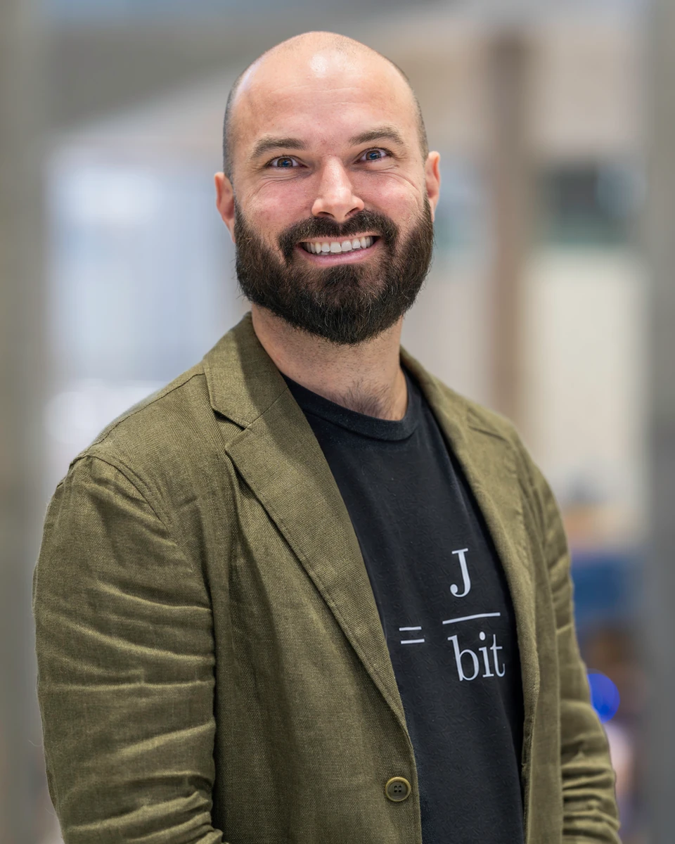 Charles Alexandre Bédard, wearing an olive jacket and a T-shirt with the J/bit motif.